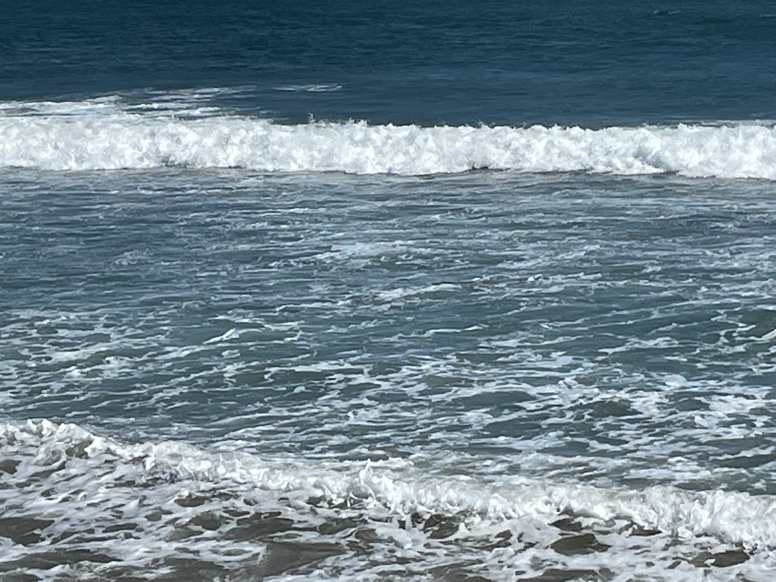 Waves glistening under the bright sun